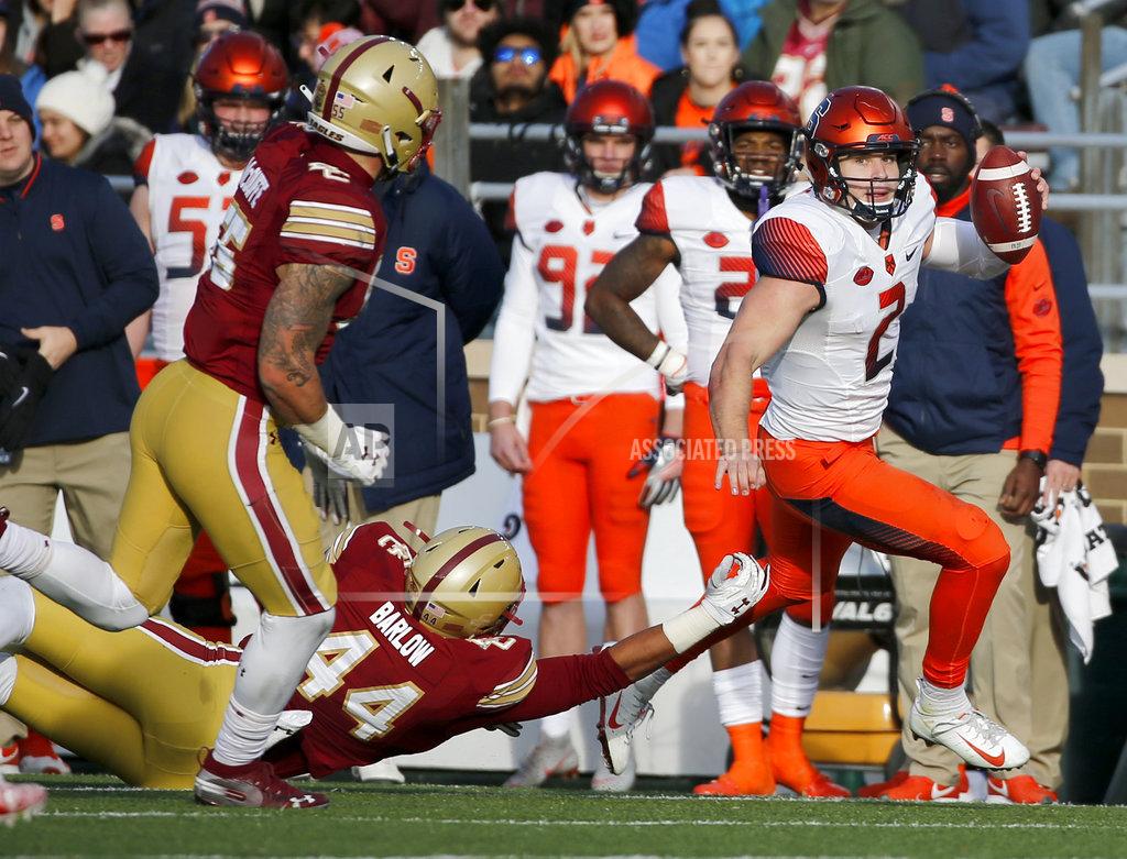 Mary Schwalm Syracuse quarterback Eric Dungey (2) rushes down the sideline ahead of a tackle attempt by Boston College defensive lineman Brandon Barlow (44) during the second half of an NCAA college football game, Saturday, Nov. 24, 2018, in Boston. (AP Photo/Mary Schwalm)