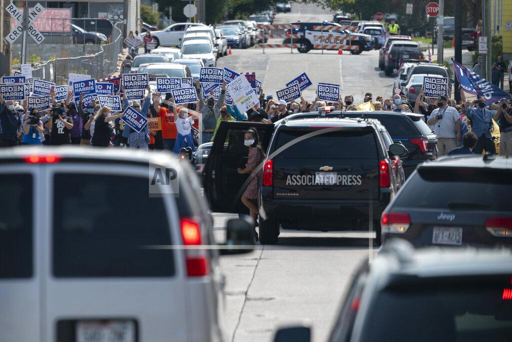 Carolyn Kaster Supporters of Democratic presidential candidate former Vice President Joe Biden cheer as a motorcade with Biden aboard arrives at Wisconsin Aluminum Foundry in Manitowoc, Wis., Monday, Sept. 21, 2020. (AP Photo/Carolyn Kaster)