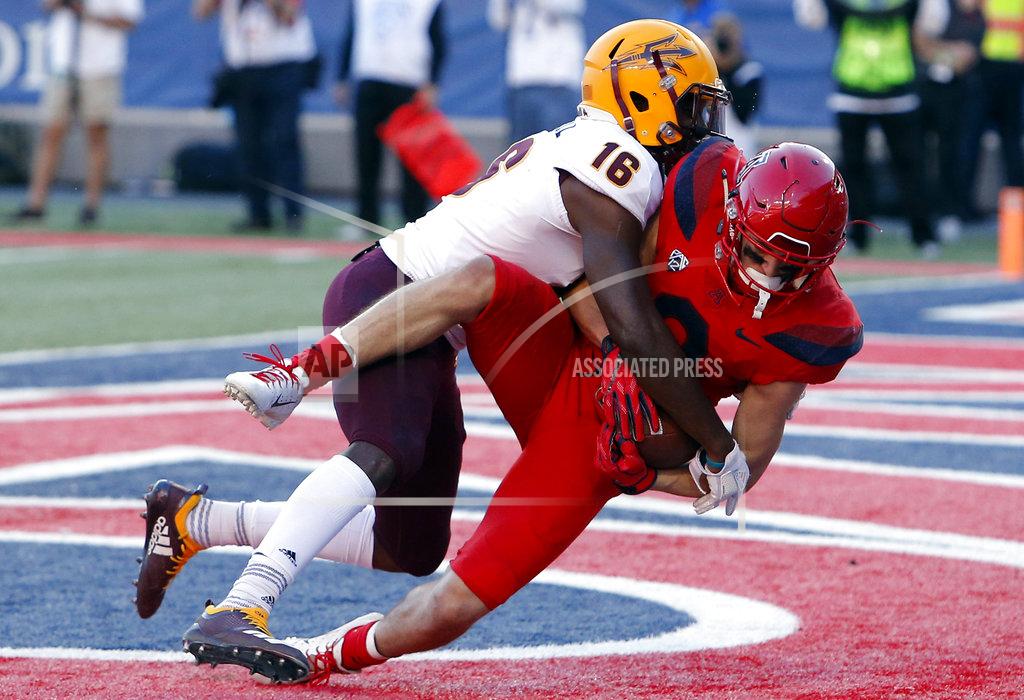 Rick Scuteri Arizona wide receiver Tony Ellison, right, holds onto the football after getting hit by Arizona State safety Aashari Crosswell (16) for a touchdown in the second half during an NCAA college football game, Saturday, Nov. 24, 2018, in Tucson, Ariz. (AP Photo/Rick Scuteri)