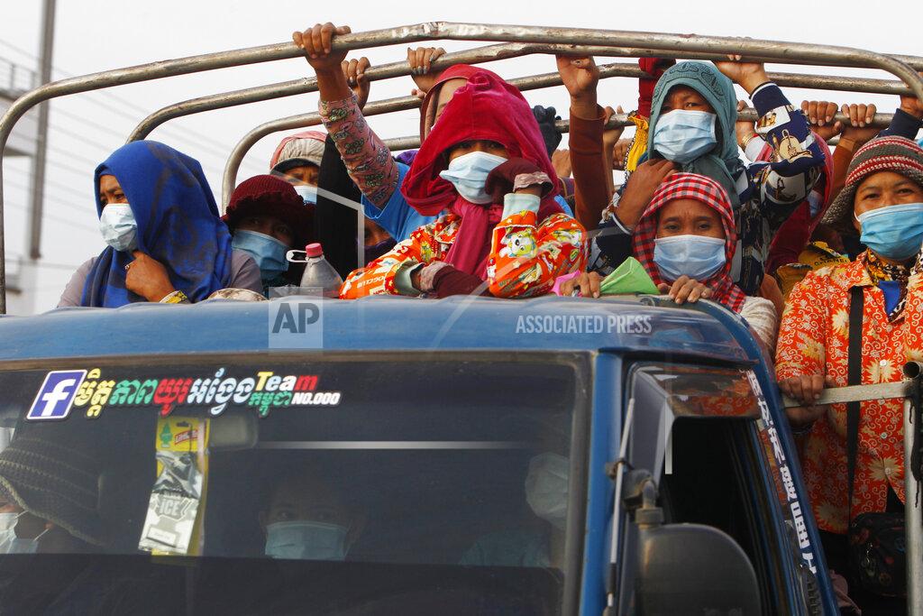 Heng Sinith Garment workers stand on a truck as they head to work outside Phnom Penh, Cambodia, Thursday, May 6, 2021. Cambodia on Thursday ended a lockdown in the capital region. (AP Photo/Heng Sinith)