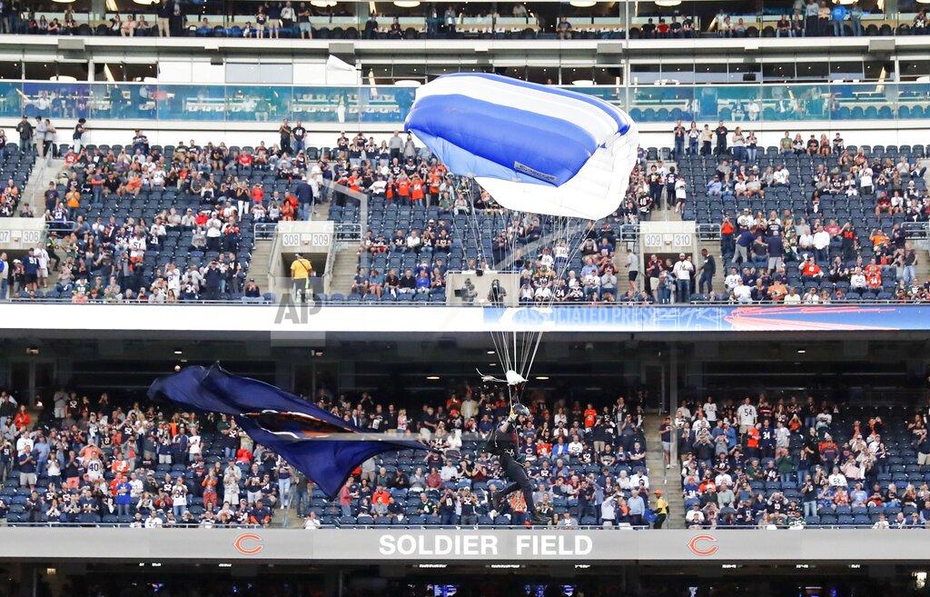 Charles Rex Arbogast A member of the U.S. Air Force parachutes into Soldier Field before an NFL football game between the Green Bay Packers and the Chicago Bears Thursday, Sept. 5, 2019, in Chicago. (AP Photo/Charles Rex Arbogast)