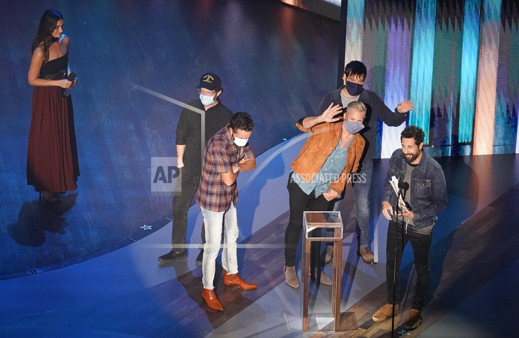 Mark Humphrey Old Dominion accepts the group of the year award as presenter Lily Aldridge, left, looks on during the 55th annual Academy of Country Music Awards at the Grand Ole Opry House on Wednesday, Sept. 16, 2020, in Nashville, Tenn. (AP Photo/Mark Humphrey)