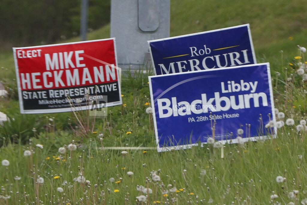 Keith Srakocic FILE - In this May 1, 2020 file photo, campaign signs for local government candidates are displayed along a roadside in Wexford, Pa. The state's primary election is June 2 and will feature legislative and congressional races, a first run for some new paper-record voting systems and the inaugural use of newly legalized mail-in ballots. Pennsylvanians have embraced the state's new vote-by-mail option that was passed last year. It has been widely adopted as a way to avoid pandemic exposure.(AP Photo/Keith Srakocic, File)