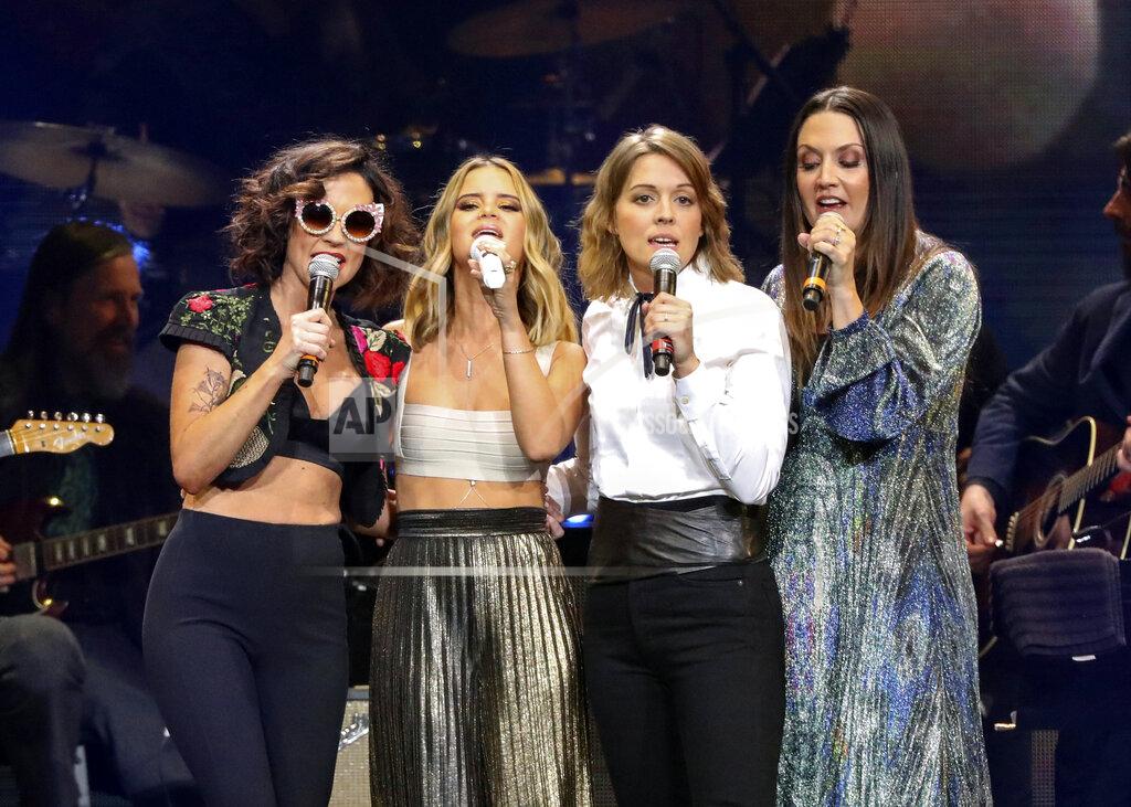 Al Wagner FILE - Amanda Shires, from left, Maren Morris, Brandi Carlile, and Natalie Hemby of The Highwomen perform at Loretta Lynn's 87th Birthday Tribute at Bridgestone Arena on Monday, April 1, 2019, in Nashville, Tenn. The Highwomen won three awards, including album, song and duo/group of the year, at the Americana Honors and Awards and the late John Prine was given artist of the year. The Americana Music Association announced the winners online this year after their awards show, normally held in Nashville, Tennessee, was cancelled because of the pandemic. (Photo by Al Wagner/Invision/AP, File)