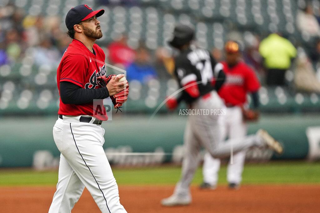 Tony Dejak Cleveland Indians starting pitcher Aaron Civale, left, waits for Chicago White Sox's Eloy Jimenez to run the bases after Jimenez hit a solo home run in the second inning in the first baseball game of a doubleheader, Thursday, Sept. 23, 2021, in Cleveland. (AP Photo/Tony Dejak)