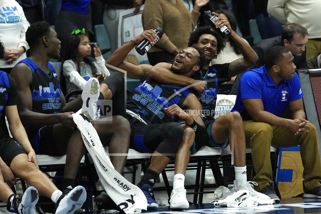 David J. Phillip Texas A&M Corpus Christi's Isaac Mushila (10) celebrates with Simeon Fryer, right, during the second half of the Southland Conference tournament NCAA college basketball game final against the Southeastern Louisiana Saturday, March 12, 2022, in Katy, Texas. Texas A&M Corpus Christi won 73-65.(AP Photo/David J. Phillip)