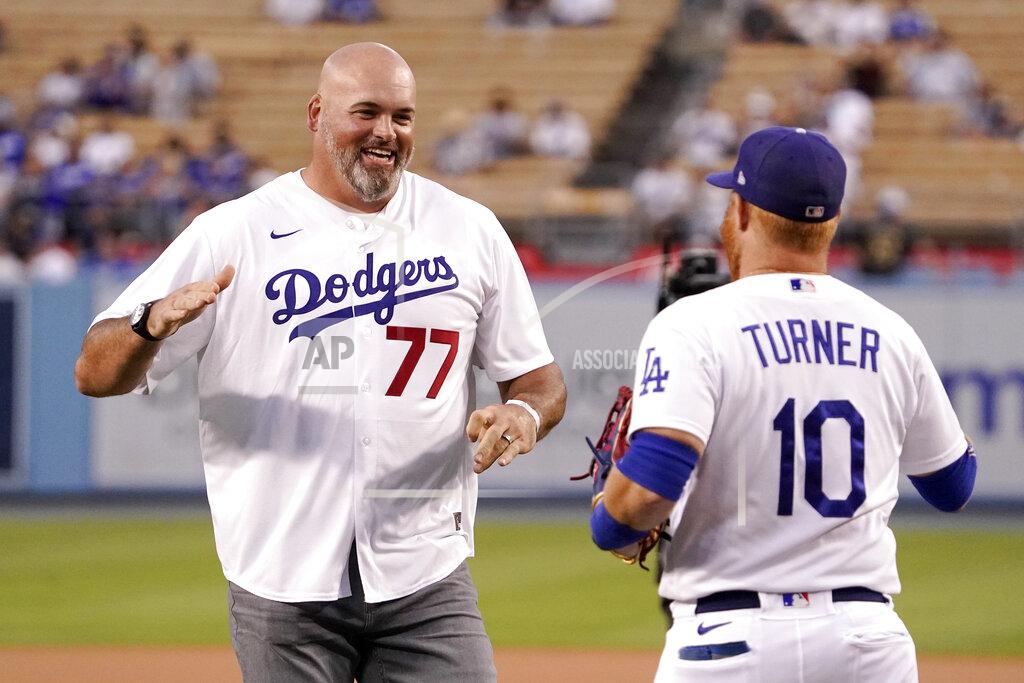 Mark J. Terrill Former Los Angeles Rams offensive lineman Andrew Whitworth, left, is congratulated by Los Angeles Dodgers' Justin Turner after throwing out the ceremonial first pitch prior to a baseball game between the Dodgers and the San Francisco Giants Tuesday, Sept. 6, 2022, in Los Angeles. (AP Photo/Mark J. Terrill)