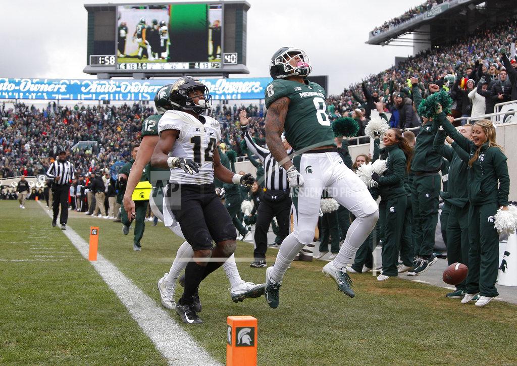 Al Goldis Michigan State's Jalen Nailor (8) celebrates after scoring a touchdown against Purdue's Antonio Blackmon (14) as Michigan State quarterback Rocky Lombardi, left rear, trails during the fourth quarter of an NCAA college football game, Saturday, Oct. 27, 2018, in East Lansing, Mich. Michigan State won 23-13. (AP Photo/Al Goldis)