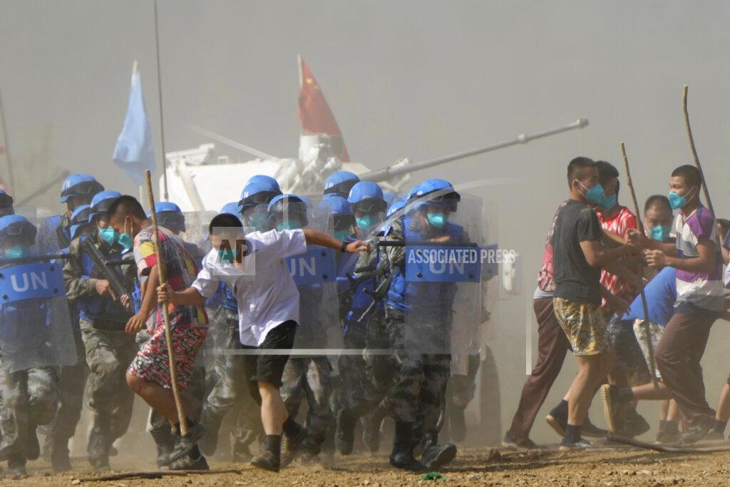 Ng Han Guan United Nations troop break up fighting in a scenario where participants playing the role of civilians fighting over water resource during the Shared Destiny 2021 drill at the Queshan Peacekeeping Operation training base in Queshan County in central China's Henan province Wednesday, Sept. 15, 2021. Peacekeeping troops from China, Thailand, Mongolia and Pakistan took part in the 10 days long exercise that field reconnaissance, armed escort, response to terrorist attacks, medical evacuation and epidemic control. (AP Photo/Ng Han Guan)