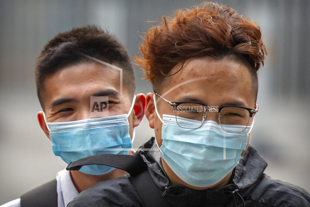 Mark Schiefelbein People wearing face masks to protect against the coronavirus ride a motor scooter in Beijing, Wednesday, July 29, 2020. China reported more than 100 new cases of COVID-19 on Wednesday as the country continues to battle an outbreak in Xinjiang. (AP Photo/Mark Schiefelbein)