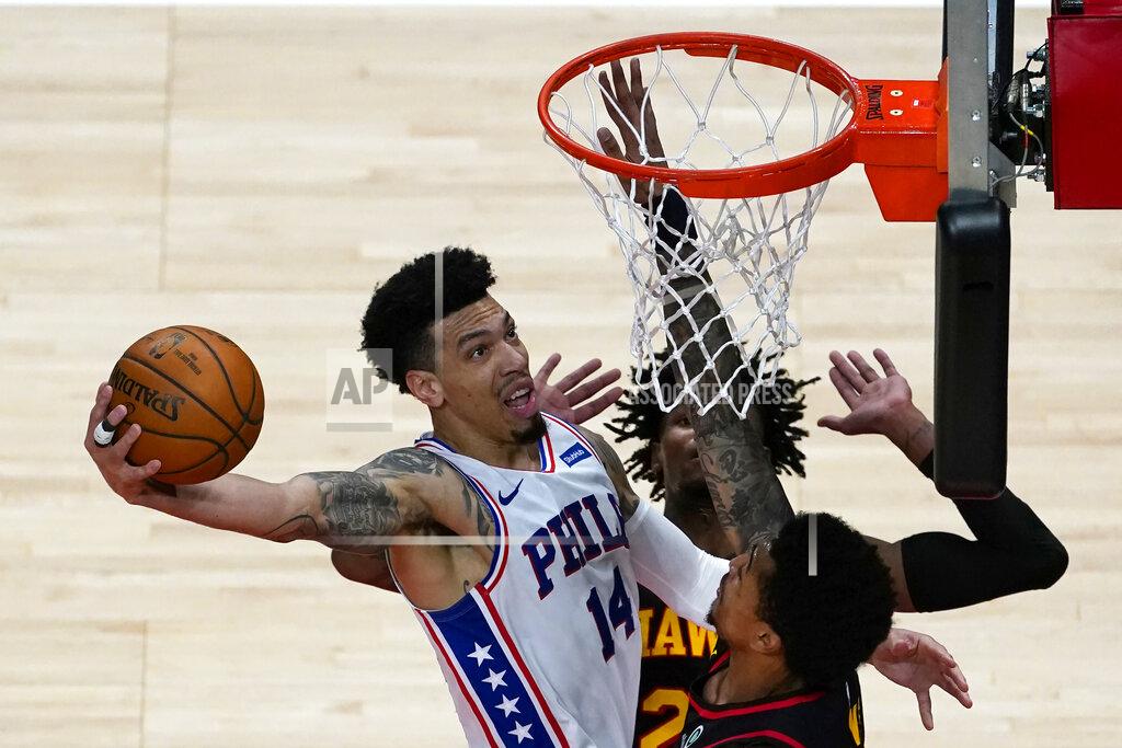 John Bazemore Philadelphia 76ers forward Danny Green (14) goes in for a basket as Atlanta Hawks' John Collins (20), right, and Bruno Fernando (24) defends during the first half of an NBA basketball game Monday, Jan. 11, 2021, in Atlanta. (AP Photo/John Bazemore)
