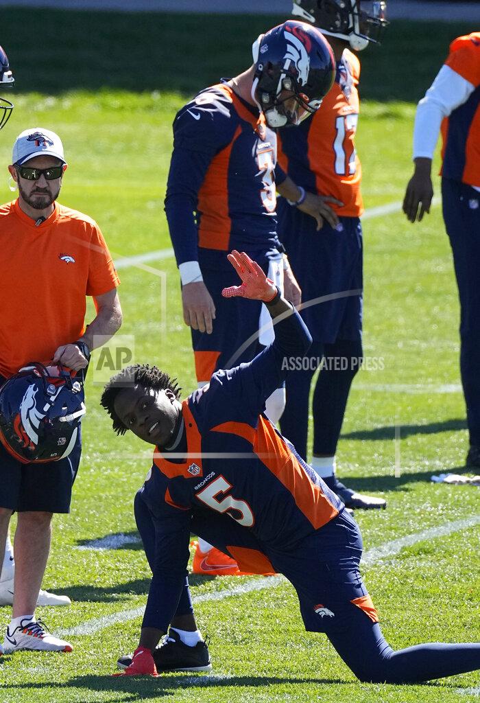 Denver Broncos quarterback Teddy Bridgewater (5) stretches in front of Drew Lock (3) during Denver Broncos OTAs at the team's headquarters Monday, May 24, 2021, in Englewood, Colo. (AP Photo/Jack Dempsey)