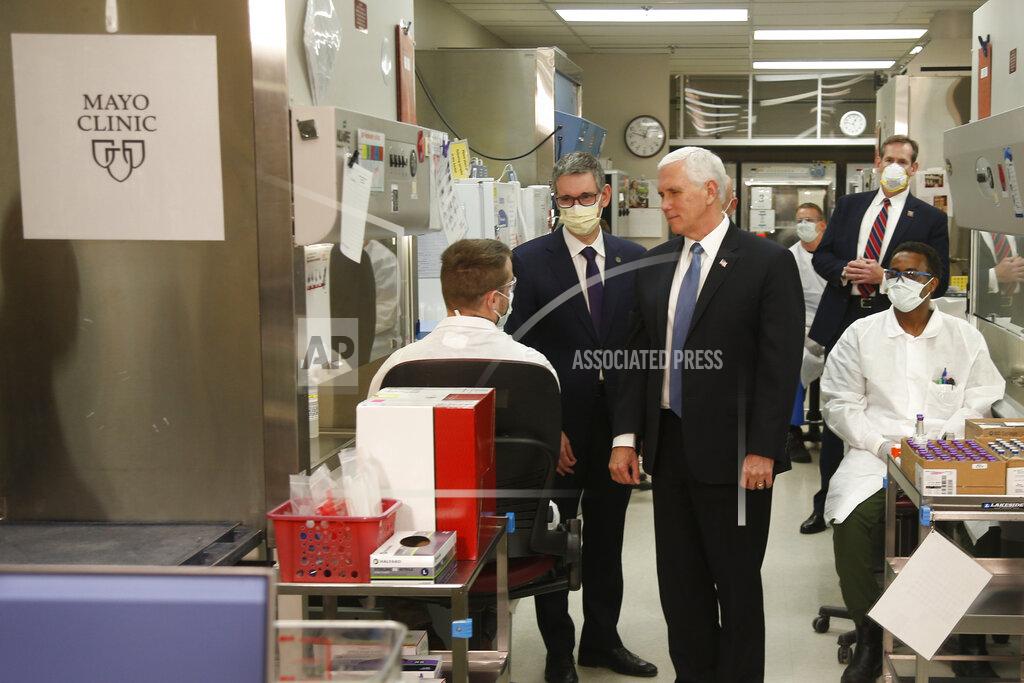 Jim Mone Vice President Mike Pence visits the molecular testing lab at Mayo Clinic Tuesday, April 28, 2020, in Rochester, Minn., where he toured the facilities supporting COVID-19 research and treatment. Pence chose not to wear a face mask while touring the Mayo Clinic in Minnesota. It's an apparent violation of the world-renowned medical center's policy requiring them. (AP Photo/Jim Mone)