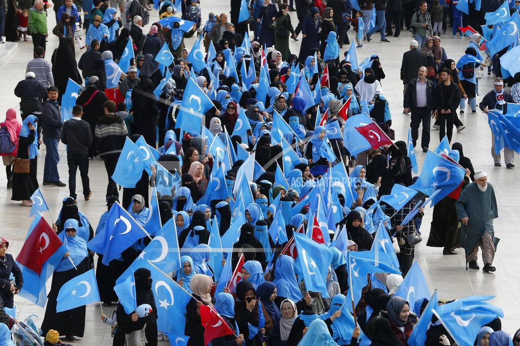 Lefteris Pitarakis FILE - In this Tuesday, Nov. 6, 2018, file photo, members of the Uighur community living in Turkey carry flags of what ethnic Uighurs call 'East Turkestan', during a protest in Istanbul, against what they allege is oppression by the Chinese government to Muslim Uighurs in far-western Xinjiang province. Because of shared cultural ties, Turkey has long been a safe haven for the Uighurs, a Turkic group native to Xinjiang. Opposition legislators in Turkey are accusing Ankara's leaders of secretly selling out Uighurs to China in exchange for coronavirus vaccines. (AP Photo/Lefteris Pitarakis, File)