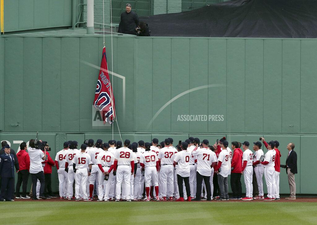 Charles Krupa The Boston Red Sox team gathers as the 2018 World Series Champions pennant is hoisted in center field before the home opener baseball game between the Red Sox and the Toronto Blue Jays, Tuesday, April 9, 2019, in Boston. (AP Photo/Charles Krupa)