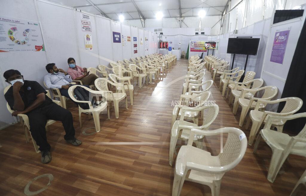 Rafiq Maqbool Health workers sit in the waiting area of vaccination center which has been closed because of shortage of the COVID-19 vaccine in Mumbai, India, Tuesday, April 20, 2021. India has decided to vaccinate everyone above 18 from May 1 as the government battles record high surge in coronavirus cases in the country. (AP Photo/Rafiq Maqbool)