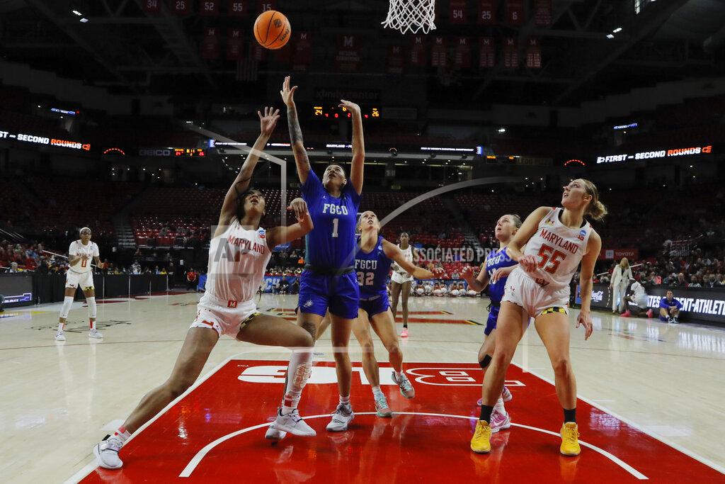 Julio Cortez Maryland forward Angel Reese (10) throws up a shot against Florida Gulf Coast guard Kierstan Bell (1) during the first half of a college basketball game in the second round of the NCAA tournament, Sunday, March 20, 2022, in College Park, Md. Maryland won 89-65. (AP Photo/Julio Cortez)