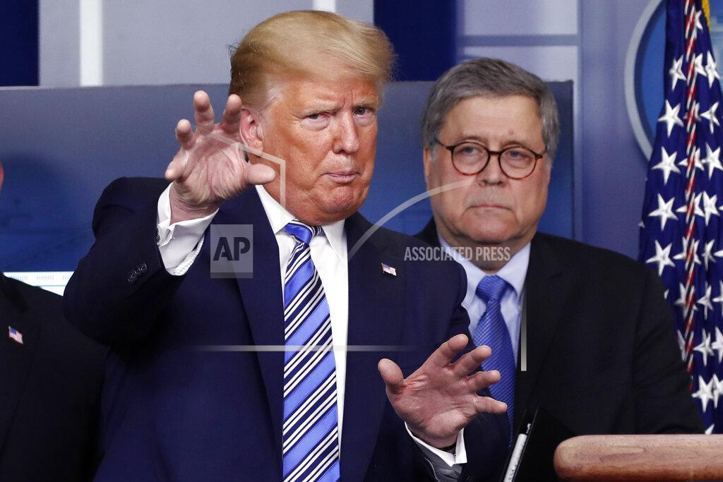 FILE- In this March 23, 2020 file photo, President Donald Trump talks during a briefing about the coronavirus in the James Brady Briefing Room, Monday, March 23, 2020, in Washington, as Attorney General William Barr looks on. Legislation to extend surveillance authorities that the FBI sees as vital in fighting terrorism was thrown in doubt Wednesday as President Donald Trump, the Justice Department and congressional Republicans all came out in opposition. (AP Photo/Alex Brandon)