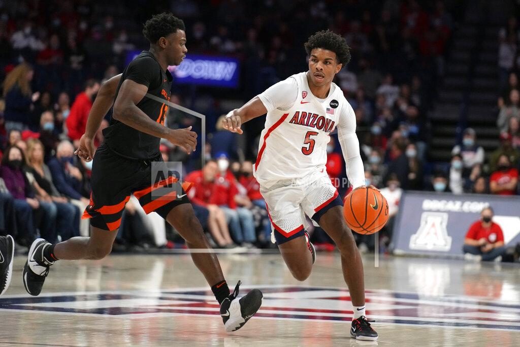 Rick Scuteri Arizona guard Justin Kier (5) drives against Oregon State guard Dashawn Davis during the second half of an NCAA college basketball game Thursday, Feb. 17, 2022, in Tucson, Ariz. Arizona won 83-69. (AP Photo/Rick Scuteri)
