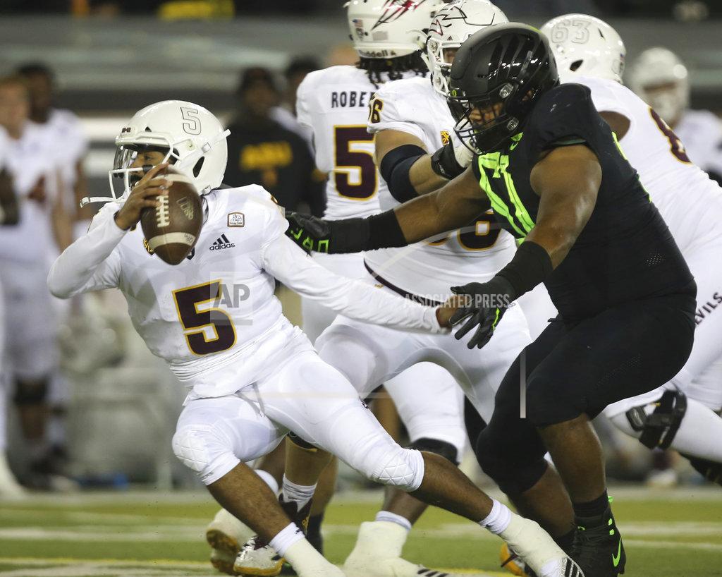 Chris Pietsch Arizona State quarterback Manny Wilkins, left, is flushed from the pocket by Oregon's Gary Baker during the second quarter of an NCAA college football game Saturday, Nov. 17, 2018, in Eugene, Ore. (AP Photo/Chris Pietsch)