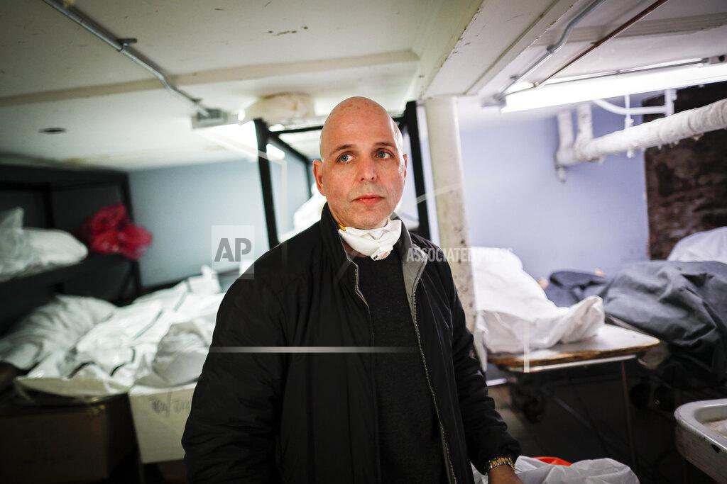 John Minchillo Pat Marmo, owner of Daniel J. Schaefer Funeral Home, walks through his body holding facility that is struggling to handle overflow of clients stemming from COVID-19 deaths, Thursday, April 2, 2020, in the Brooklyn borough of New York. "This is a state of emergency," he said. "We need help." (AP Photo/John Minchillo)