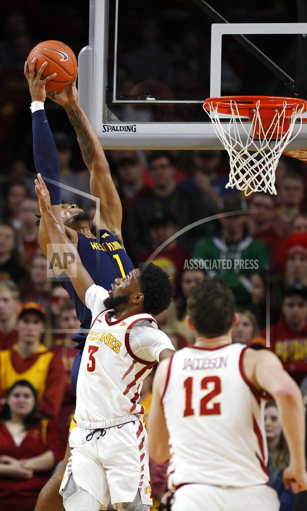 Matthew Putney West Virginia forward Derek Culver, top, jumps aboe Iowa State guard Tre Jackson, center, for a rebound during the first half of an NCAA college basketball game Tuesday, March 3, 2020, in Ames, Iowa. (AP Photo/Matthew Putney)