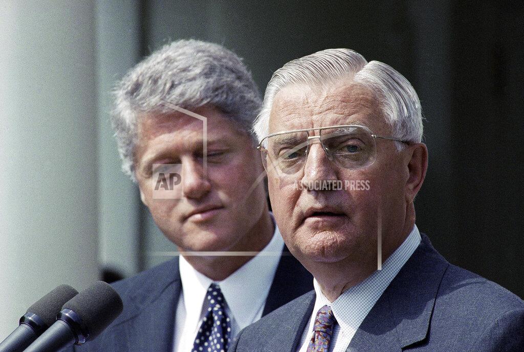 Greg Gibson FILE - In this June 1993 file photo, President Bill Clinton stands behind his nominee for Ambassador to Japan, former Vice President Walter Mondale. Mondale, a liberal icon who lost the most lopsided presidential election after bluntly telling voters to expect a tax increase if he won, died Monday, April 19, 2021. He was 93. (AP Photo/Greg Gibson, File)