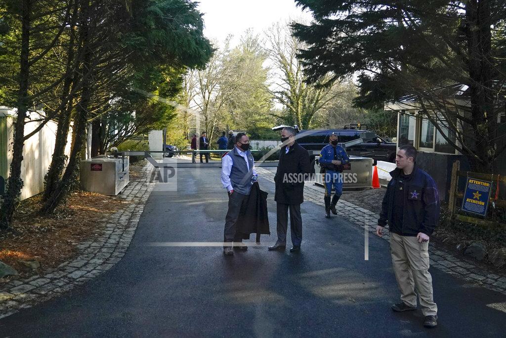 Patrick Semansky FILE - In this Feb. 21, 2021, file photo security personnel stand at the entrance to President Joe Biden and first lady Jill Biden's home in Wilmington, Del. The Bidens are spending the weekend in Delaware. Since taking office, he has spent this weekend and several others in his adopted home state. (AP Photo/Patrick Semansky, File)