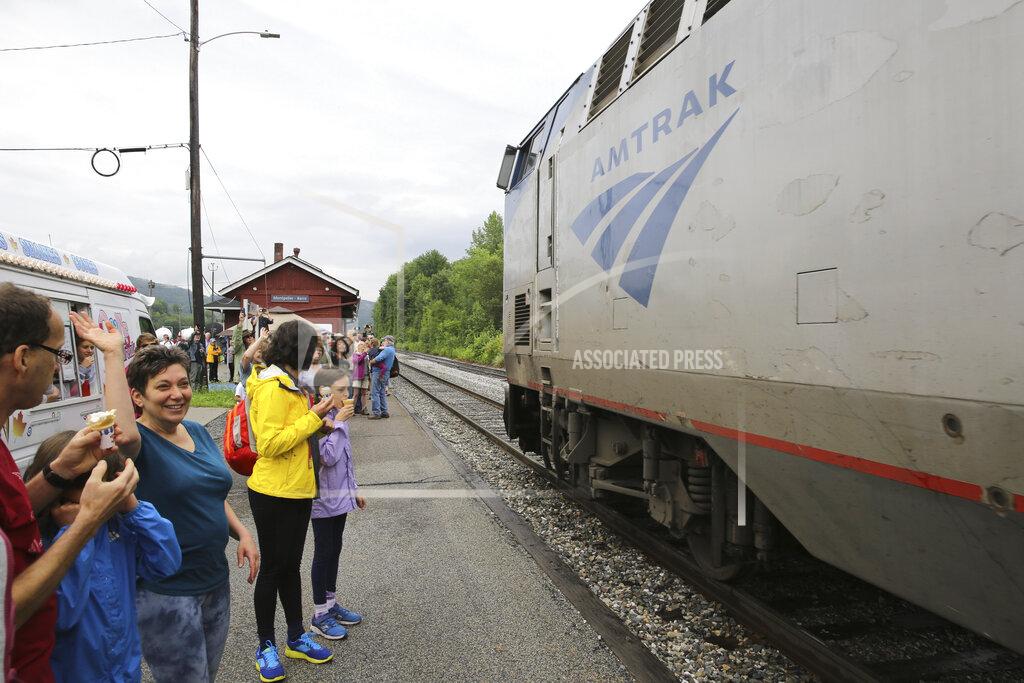 Wilson Ring Onlookers wave as the Amtrak Vermonter passenger train arrives at the Montpelier station, in Berlin, Vt., on Monday July 19, 2021. A celebration was held at Amtrak stations across Vermont to mark the return of the passenger trains to Vermont for the first time since they were suspended at the beginning of the COVID-19 pandemic. (AP Photo/Wilson Ring)