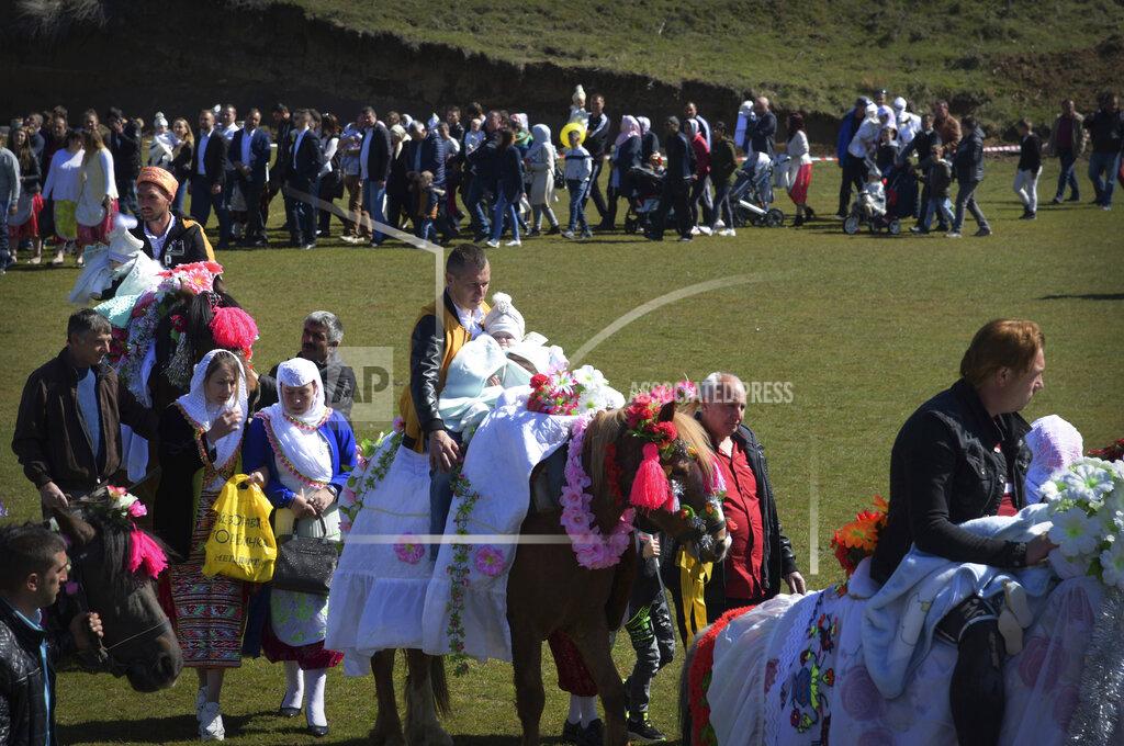 Jordan Simeonov Bulgarian muslims walk in a procession during mass circumcision ceremony in the village of Ribnovo, Bulgaria, Sunday, April 11, 2021. Despite the dangers associated with COVID-19 and government calls to avoid large gatherings, Hundreds of people flocked to the tiny village of Ribnovo in southwestern Bulgaria for a four-day festival of feasting, music and the ritual of circumcision which is considered by Muslims a religious duty and essential part of a man's identity. (AP Photo/Jordan Simeonov)