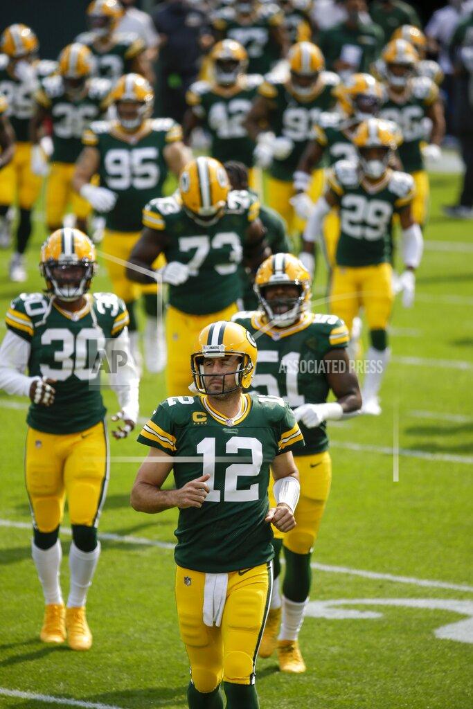 Mike Roemer Green Bay Packers' Aaron Rodgers runs on the field with teammates before an NFL football game against the Detroit Lions Sunday, Sept. 20, 2020, in Green Bay, Wis. (AP Photo/Mike Roemer)