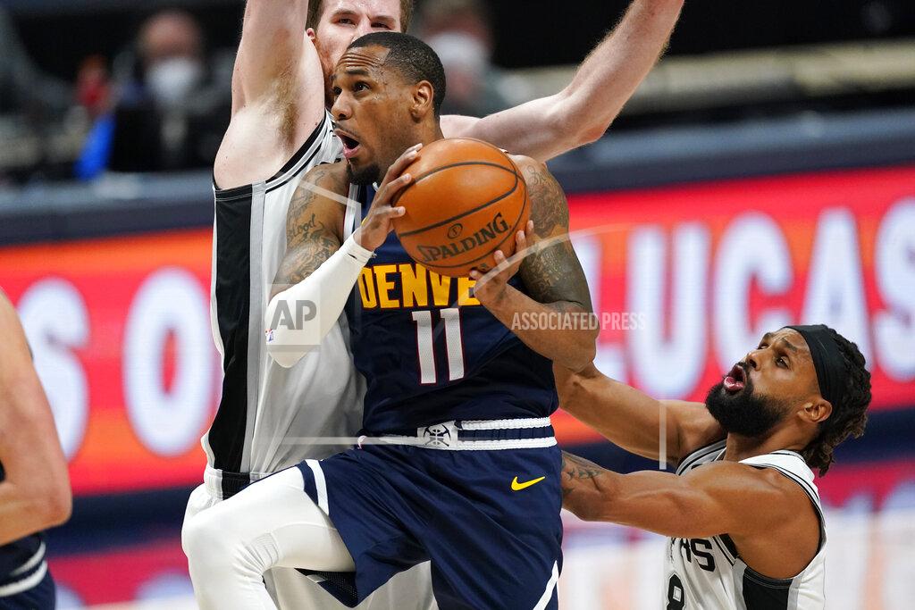David Zalubowski Denver Nuggets guard Monte Morris, front left, drives to the basket past San Antonio Spurs center Jakob Poeltl, back left, and guard Patty Mills in the second half of an NBA basketball game Friday, April 9, 2021, in Denver. (AP Photo/David Zalubowski)