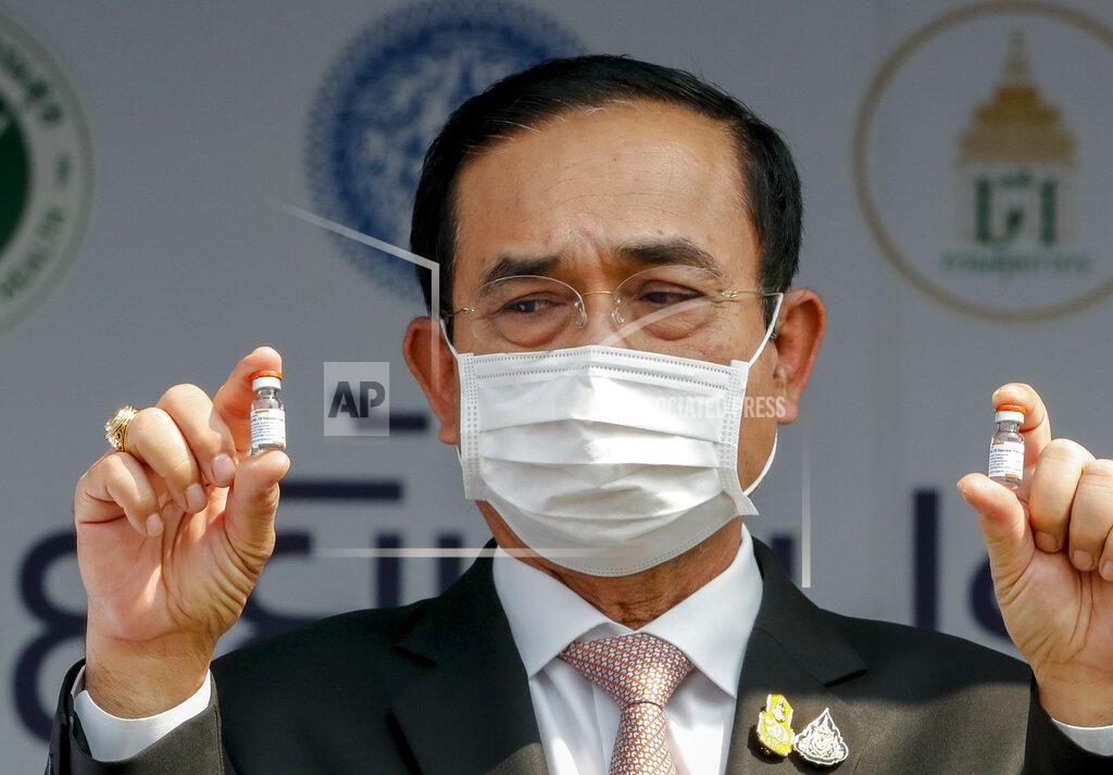 Sakchai Lalit Prime Minister Prayuth Chan-ocha holds samples of Sinovac vaccine during a ceremony to mark the arrival of 200,000 doses of the Sinovac vaccine shipment at Suvarnabhumi airport in Bangkok, Thailand, Wednesday, Feb. 24, 2021. Thailand is schedule to receive first shipments of 200,000 doses of the Sinovac vaccine and 117,000 doses of the AstraZeneca vaccine on Feb. 24. (AP Photo/Sakchai Lalit)