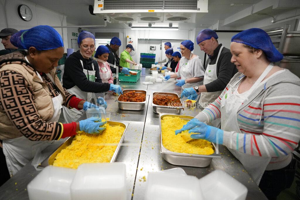 Frank Augstein Volunteers from the charity 'The Felix Project' prepare meals in the kitchen of their hub in London, Wednesday, May 4, 2022. Across Britain, food banks and community food hubs that helped struggling families, older people and the homeless during the pandemic are now seeing soaring demand. The cost of food and fuel in the U.K. has risen sharply since late last year, with inflation reaching the highest level in 40 years. (AP Photo/Frank Augstein)