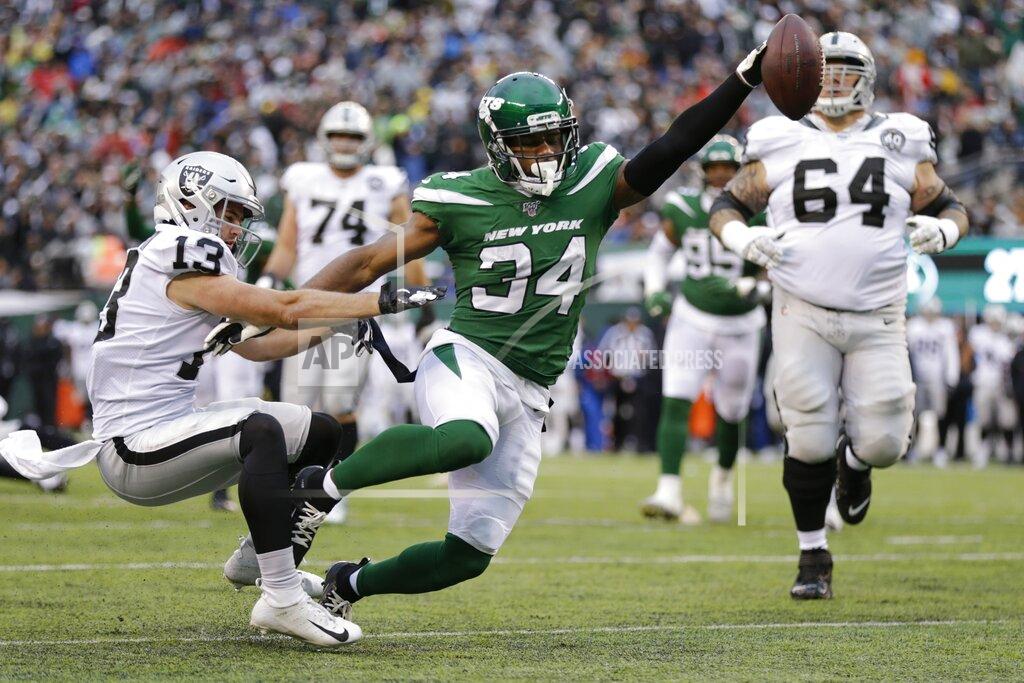 Adam Hunger New York Jets' Brian Poole (34) breaks a tackle by Oakland Raiders' Hunter Renfrow (13) to score a touchdown after intercepting a pass during the second half of an NFL football game Sunday, Nov. 24, 2019, in East Rutherford, N.J. (AP Photo/Adam Hunger)