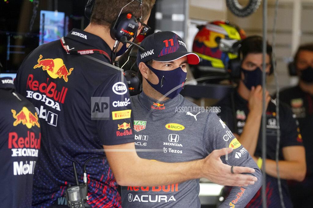 Darron Cummings Red Bull driver Sergio Perez, of Mexico, talks with a crew member during a practice session for the Formula One U.S. Grand Prix auto race at the Circuit of the Americas, Saturday, Oct. 23, 2021, in Austin, Texas. (AP Photo/Darron Cummings)
