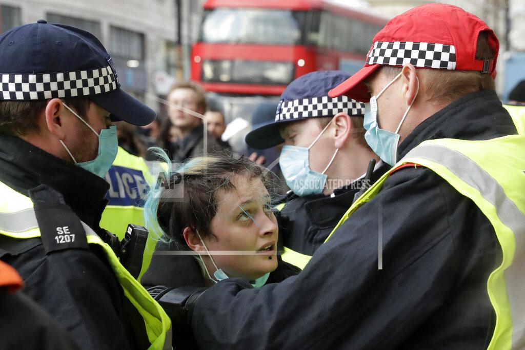 Matt Dunham A woman is restrained by police during a 'Kill the Bill' protest in London, Saturday, April 3, 2021. The demonstration is against the contentious Police, Crime, Sentencing and Courts Bill, which is currently going through Parliament and would give police stronger powers to restrict protests. (AP Photo/Matt Dunham)