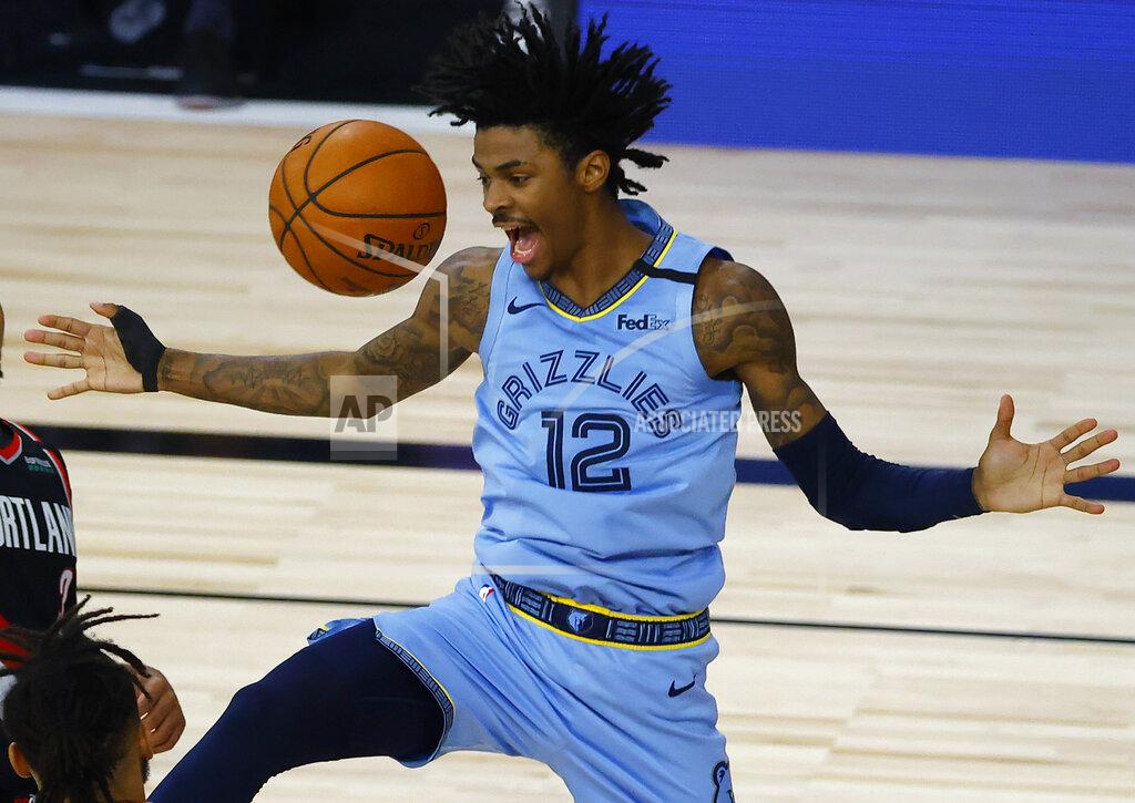 Kevin C. Cox Memphis Grizzlies' Ja Morant reacts after a dunk against the Portland Trail Blazers during the second half of an NBA basketball game Saturday, Aug. 15, 2020, in Lake Buena Vista, Fla. (Kevin C. Cox/Pool Photo via AP)