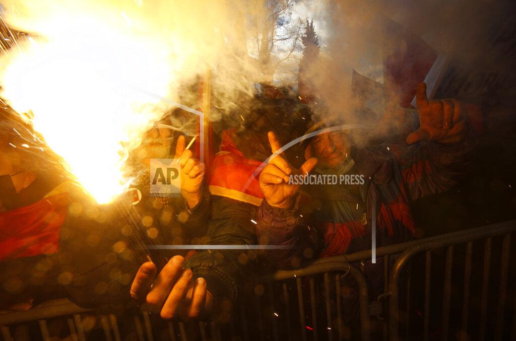 Risto Bozovic People shout slogans during a protest against the new government in Podgorica, Montenegro, Monday, Dec. 28, 2020. Several thousand people rallied Monday in Montenegro, accusing the new government of being pro-Serb because of its plans to amend a religious property law that is strongly opposed by the Serbian Orthodox Church. (AP Photo/Risto Bozovic)