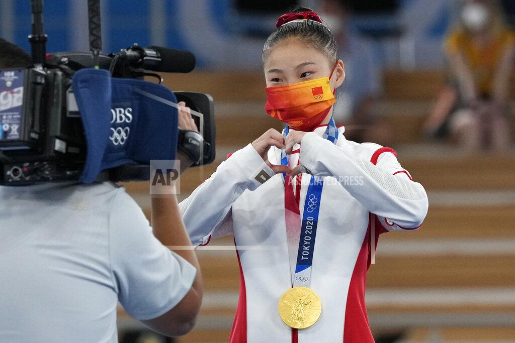 Gregory Bull Guan Chenchen, of China, reacts after winning the gold medal on the balance beam during the artistic gymnastics women's apparatus final at the 2020 Summer Olympics, Tuesday, Aug. 3, 2021, in Tokyo, Japan. (AP Photo/Gregory Bull)