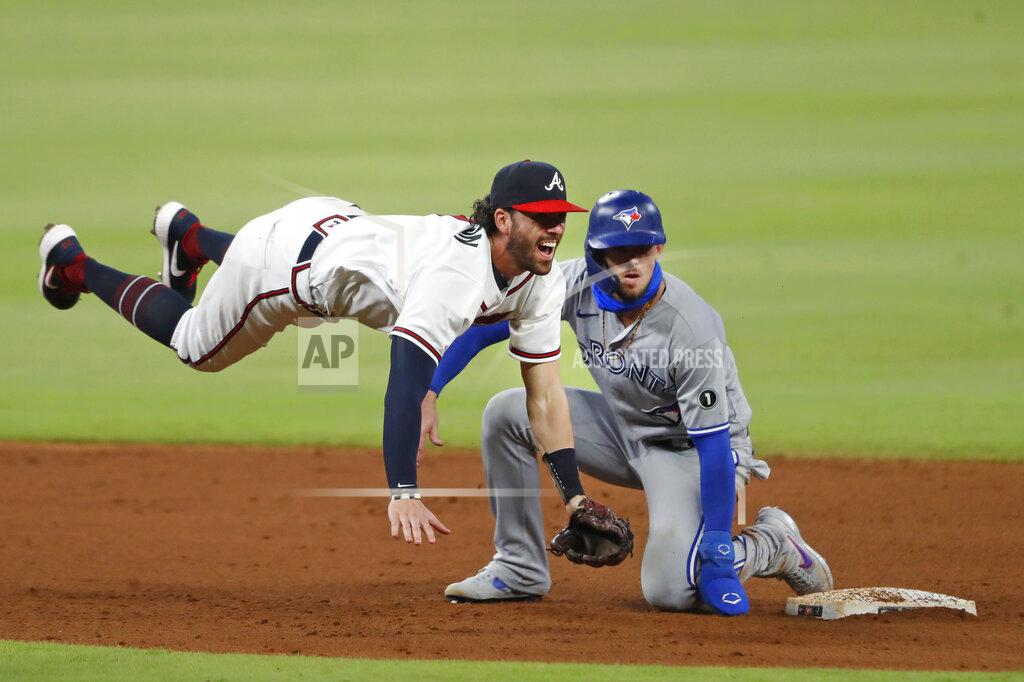 John Bazemore Atlanta Braves shortstop Dansby Swanson (7) avoids Toronto Blue Jays' Cavan Biggio (8) as he turns a double play on a Teoscar Hernandez ground ball in the sixth inning of a baseball game Tuesday, Aug. 4, 2020, in Atlanta. (AP Photo/John Bazemore)