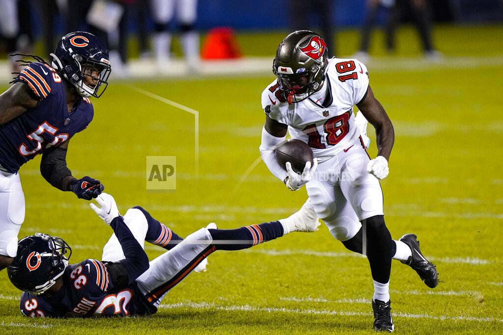 Nam Y. Huh Tampa Bay Buccaneers wide receiver Tyler Johnson (18) runs past Chicago Bears cornerback Jaylon Johnson (33) and inside linebacker Danny Trevathan (59) after a catch during the first half of an NFL football game in Chicago, Thursday, Oct. 8, 2020. (AP Photo/Nam Y. Huh)