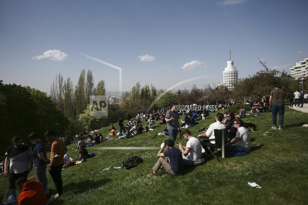 Burhan Ozbilici People sit in a park in Ankara, Turkey, Thursday, April 29, 2021, just hours before the start of a three-week full lockdown. People stocked up on groceries, shoppers filled markets and many left cities for their hometowns or the southern coast as Turkey's strictest COVID-19 lockdown yet comes into effect later on Thursday. President Recep Tayyip Erdogan imposed a "full lockdown" from Thursday evening until May 17 amid soaring COVID-19 infections and deaths. Turkey now ranks among the world's worst-hit countries. (AP Photo/Burhan Ozbilici)