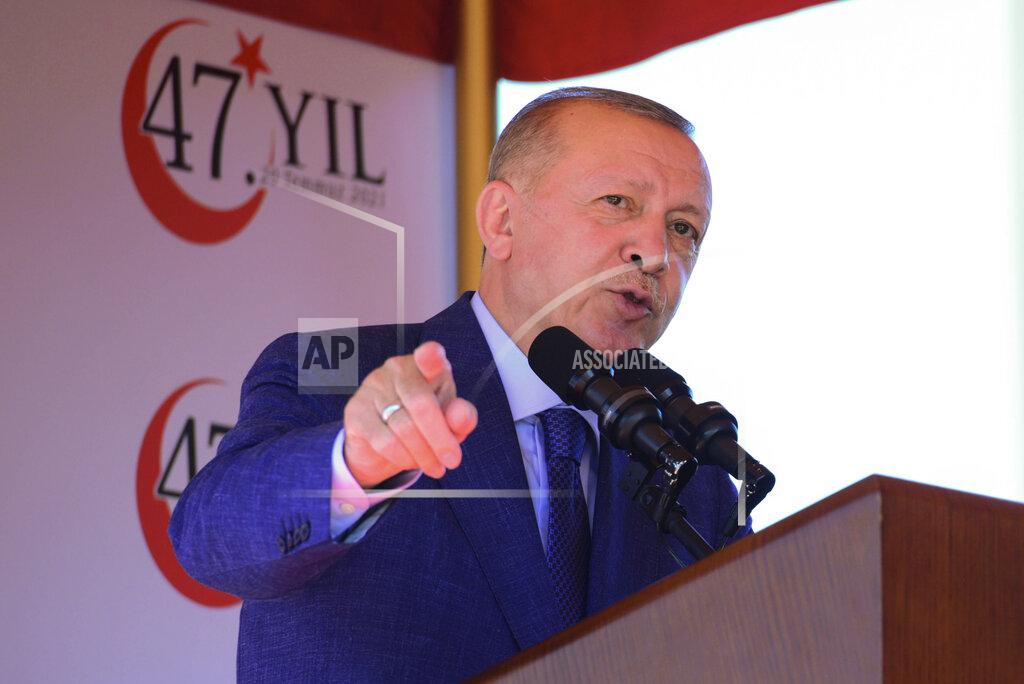 Nedim Enginsoy Turkish President Recep Tayyip Erdogan, talks before the military parade marking the 47th anniversary of the 1974 Turkish invasion in the Turkish occupied area of the divided capital Nicosia, Cyprus, Tuesday, July 20, 2021. The only route to lasting peace on ethnically divided Cyprus is through the international community's acceptance of two separate states on the east Mediterranean island nation, Turkey's president said. (AP Photo/Nedim Enginsoy)
