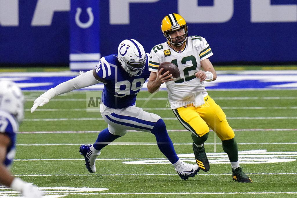 Aj Mast Green Bay Packers quarterback Aaron Rodgers (12) runs from Indianapolis Colts' DeForest Buckner (99) during the first half of an NFL football game, Sunday, Nov. 22, 2020, in Indianapolis. (AP Photo/AJ Mast)