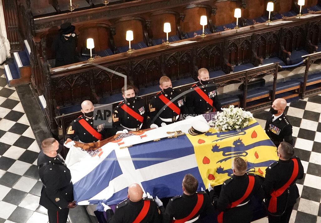 Jonathan Brady Britain's Queen Elizabeth II looks on the flag draped coffin as she sits alone in St. George’s Chapel during the funeral of Prince Philip, the man who had been by her side for 73 years, at Windsor Castle, Windsor, England, Saturday April 17, 2021. Prince Philip died April 9 at the age of 99 after 73 years of marriage to Britain's Queen Elizabeth II. (Jonathan Brady/Pool via AP)