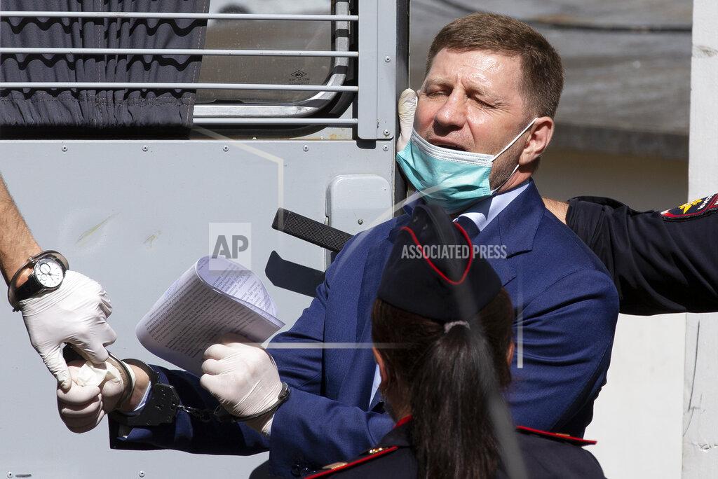 Alexander Zemlianichenko FILE - In this July 10, 2020, file photo, Sergei Furgal, governor of the Khabarovsk region in Russia's Far East region, is escorted from a courtroom in Moscow, Russia. Furgal was arrested on charges of being involved in killings. (AP Photo/Alexander Zemlianichenko, File)