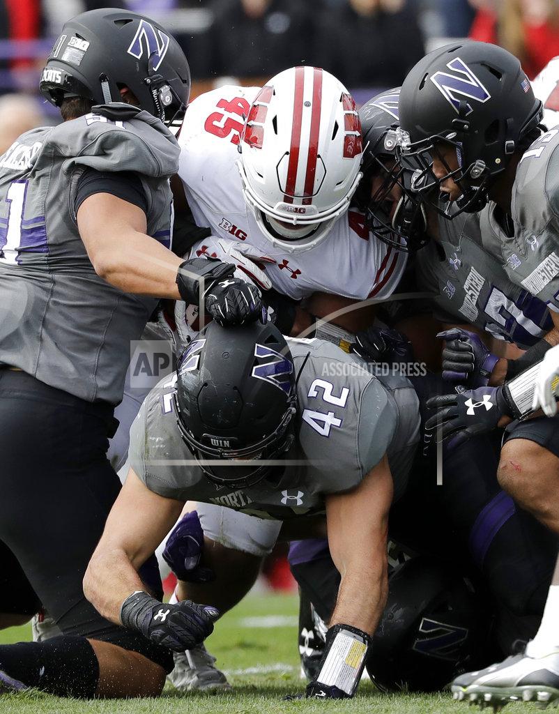 Nam Y. Huh Wisconsin fullback Alec Ingold (45) is tackled by Northwestern defenders during the first half of an NCAA college football game in Evanston, Ill., Saturday, Oct. 27, 2018. (AP Photo/Nam Y. Huh)