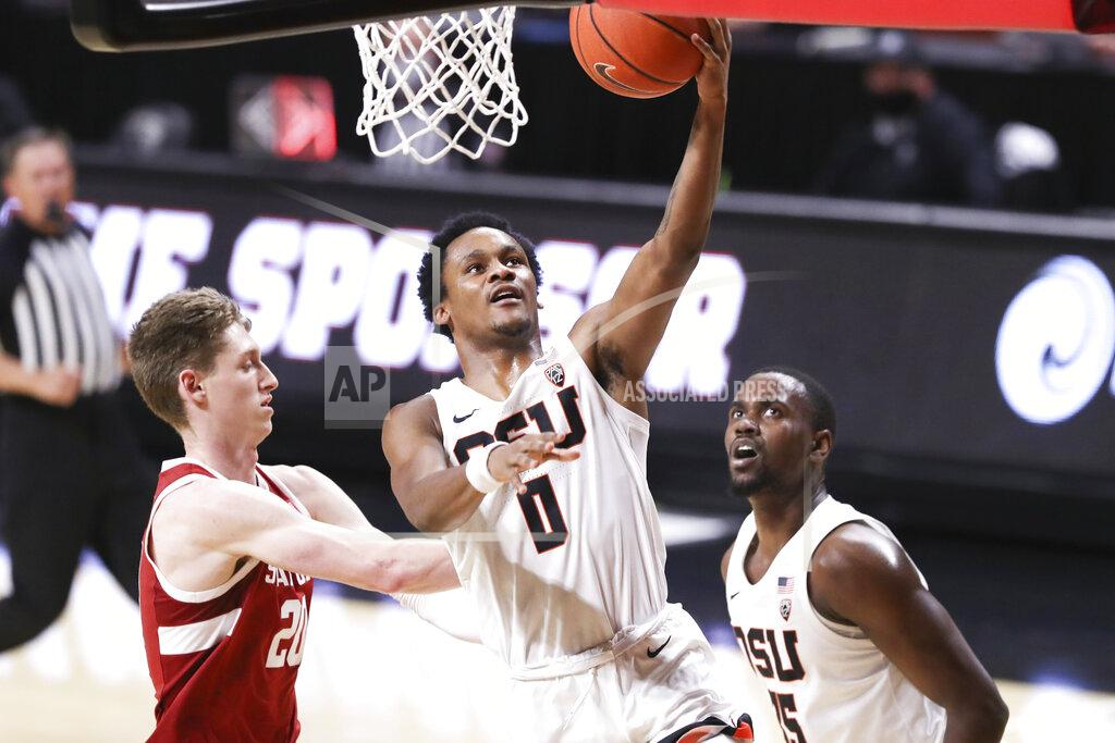 Amanda Loman Oregon State's Gianni Hunt (0) makes it to the basket past Stanford's Noah Taitz (20) as teammate Dearon Tucker (35) looks on during the first half of an NCAA college basketball game in Corvallis, Ore., Monday, Jan. 4, 2021. (AP Photo/Amanda Loman)