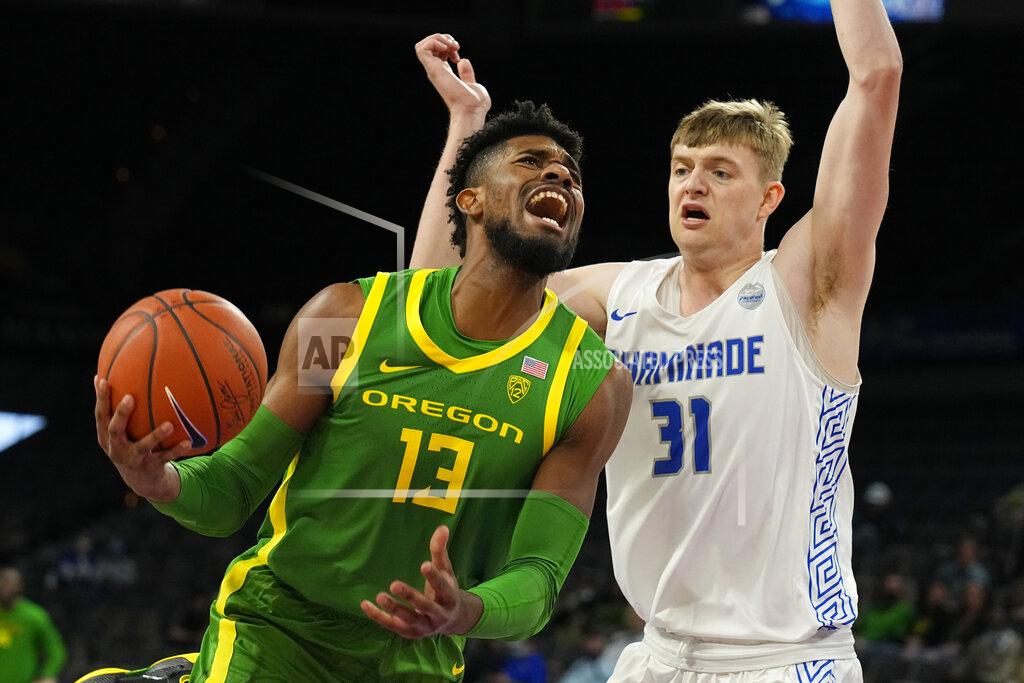 Rick Scuteri Oregon forward Quincy Guerrier drives against Chaminade center Joseph Smoyer (31) in the first half during an NCAA college basketball game at the Maui Invitational in Las Vegas, Monday, Nov. 22, 2021. (AP Photo/Rick Scuteri)